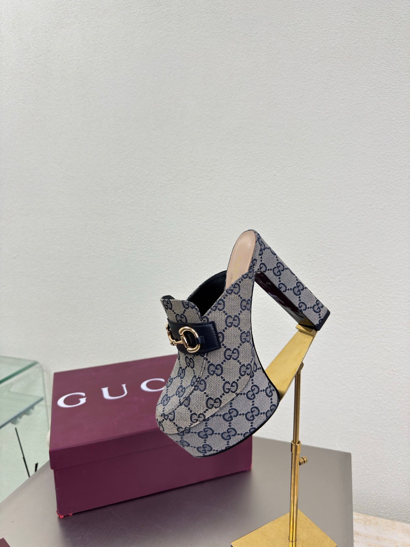 Gucci platform mule on tall gold heel stand, blue GG canvas and gold trim
