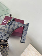 Gucci mule upper close-up in blue GG canvas with gold horsebit buckle