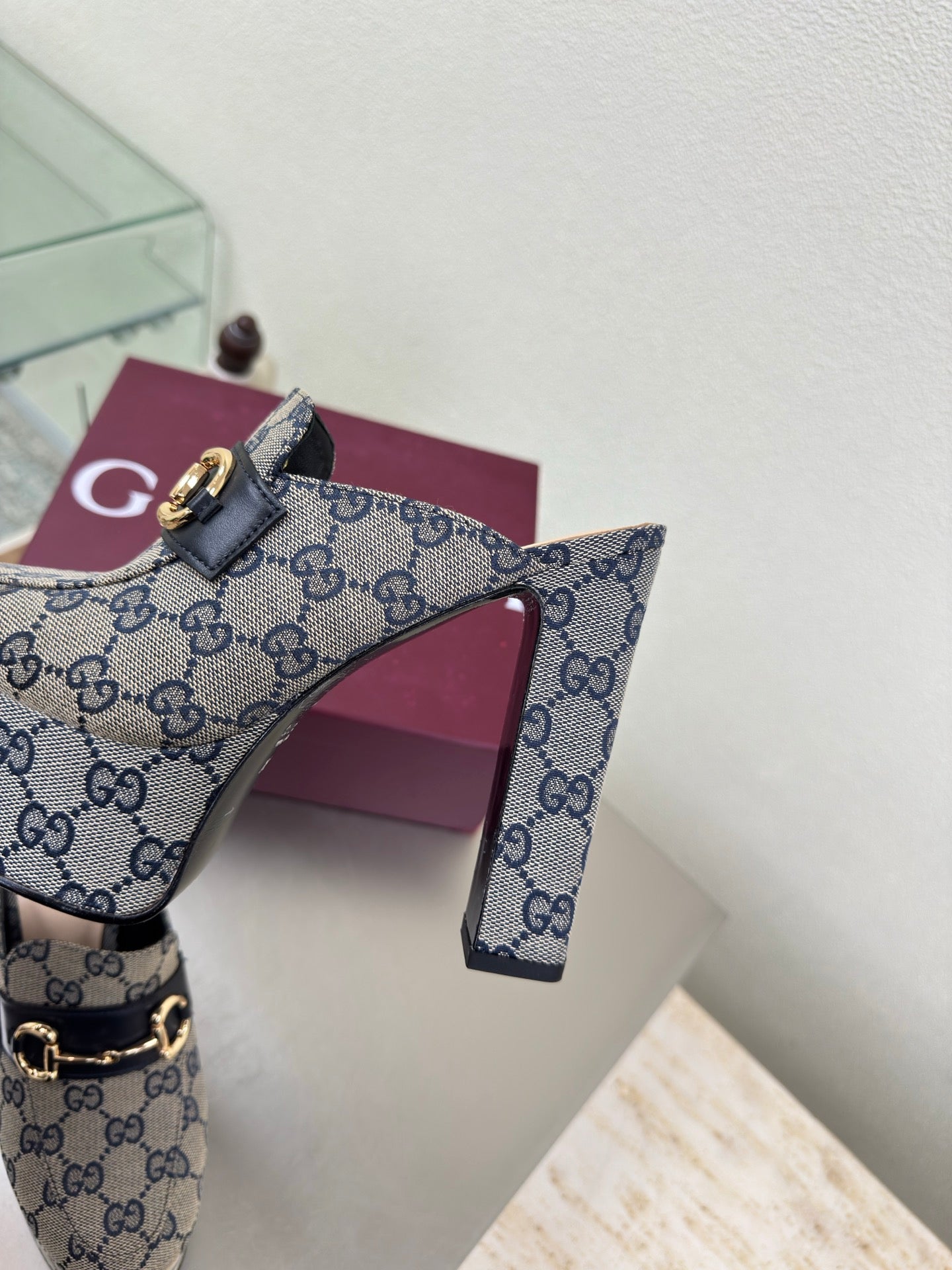 Gucci mule upper close-up in blue GG canvas with gold horsebit buckle