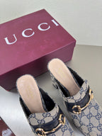 Gucci platform mule pair with GG pattern, gold horsebit buckle, and black heel