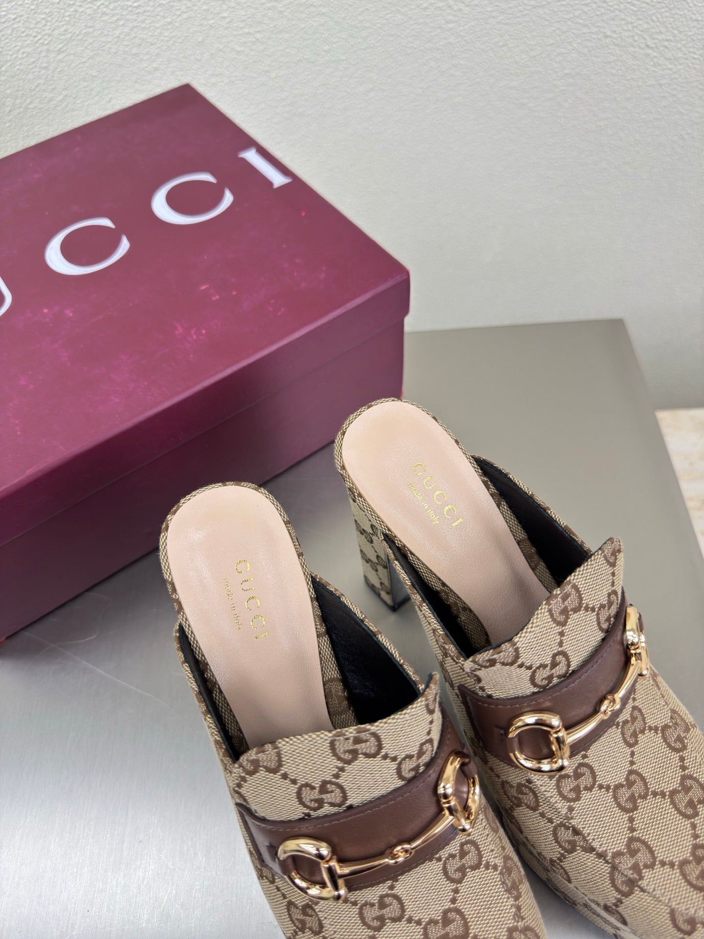 Pair of Gucci GG canvas mule loafers with gold-tone horsebit, open heel
