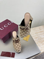 Gucci GG canvas mule loafers with gold-tone horsebit, heel and toe shown