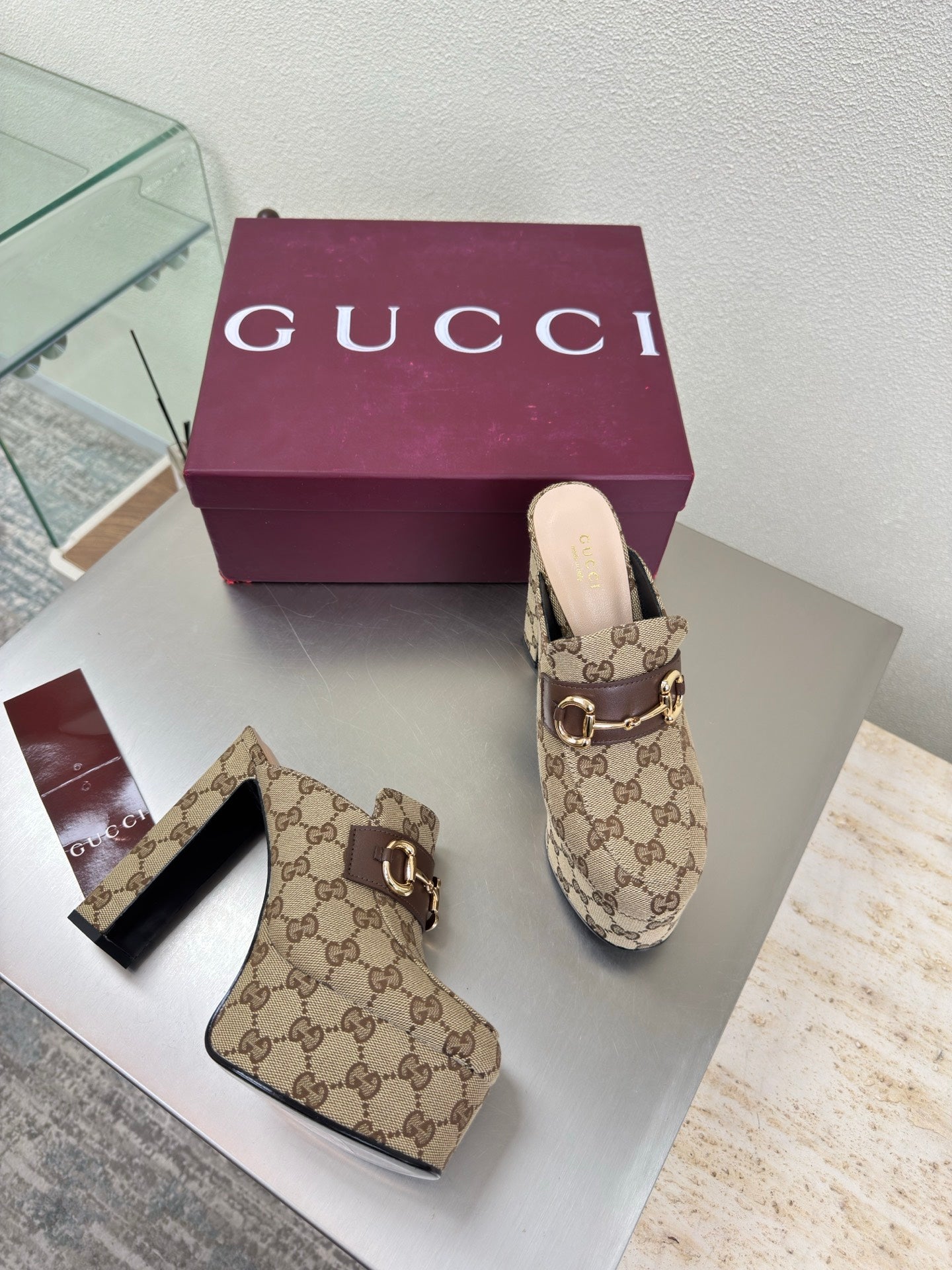 Gucci GG canvas mule loafers with gold-tone horsebit, front and side angles