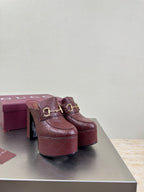 Burgundy Gucci platform mules with gold horsebit buckle, textured finish
