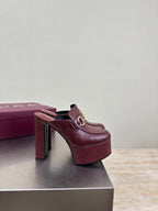 Burgundy Gucci mule sandals with gold horsebit buckle and high block heel