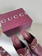 Burgundy Gucci heeled mules, gold horsebit strap on textured leather