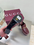 Burgundy Gucci mules with gold horsebit buckle and textured leather, box view