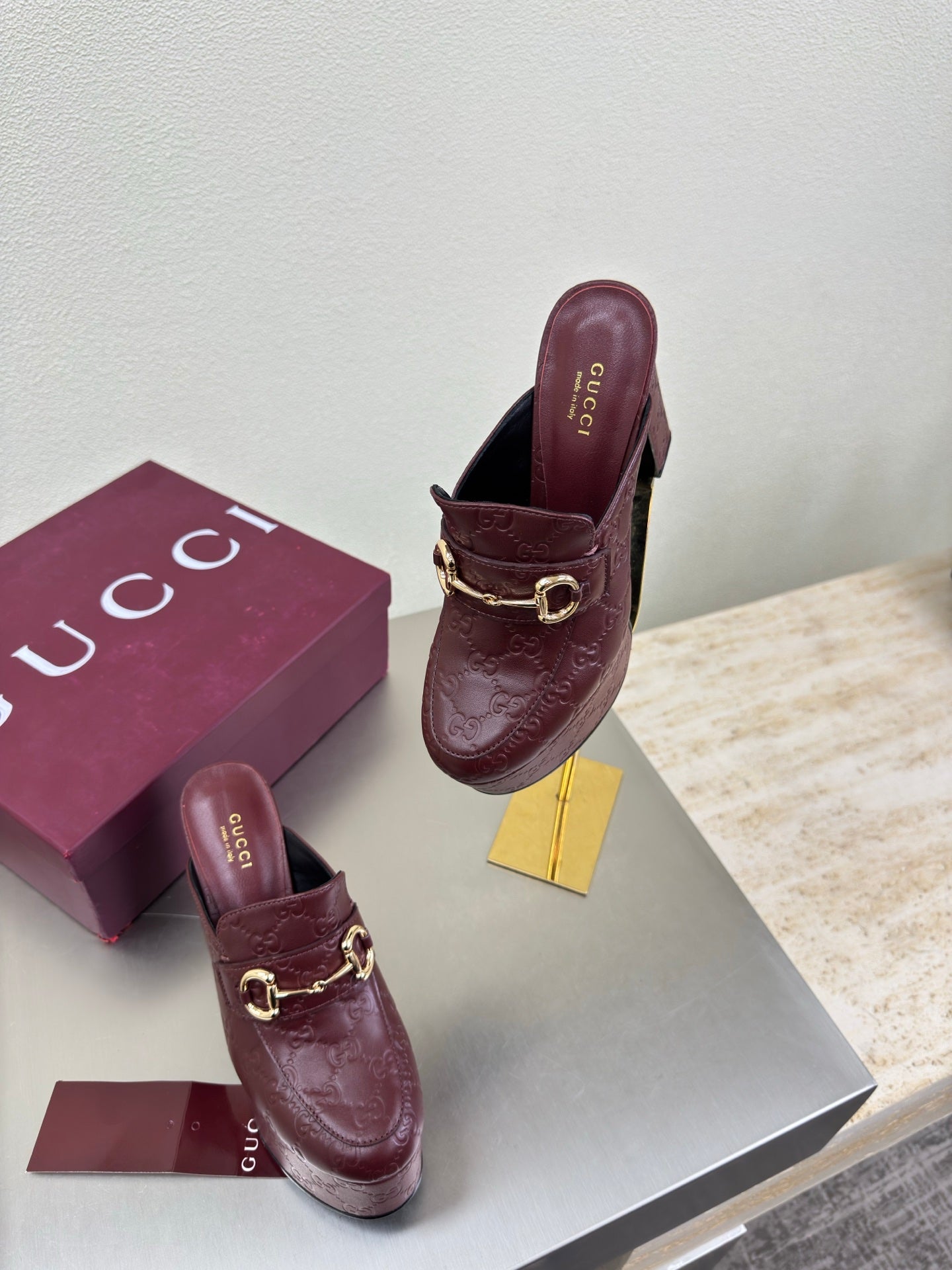 Pair of burgundy Gucci heeled mules with gold horsebit detail and textured leather