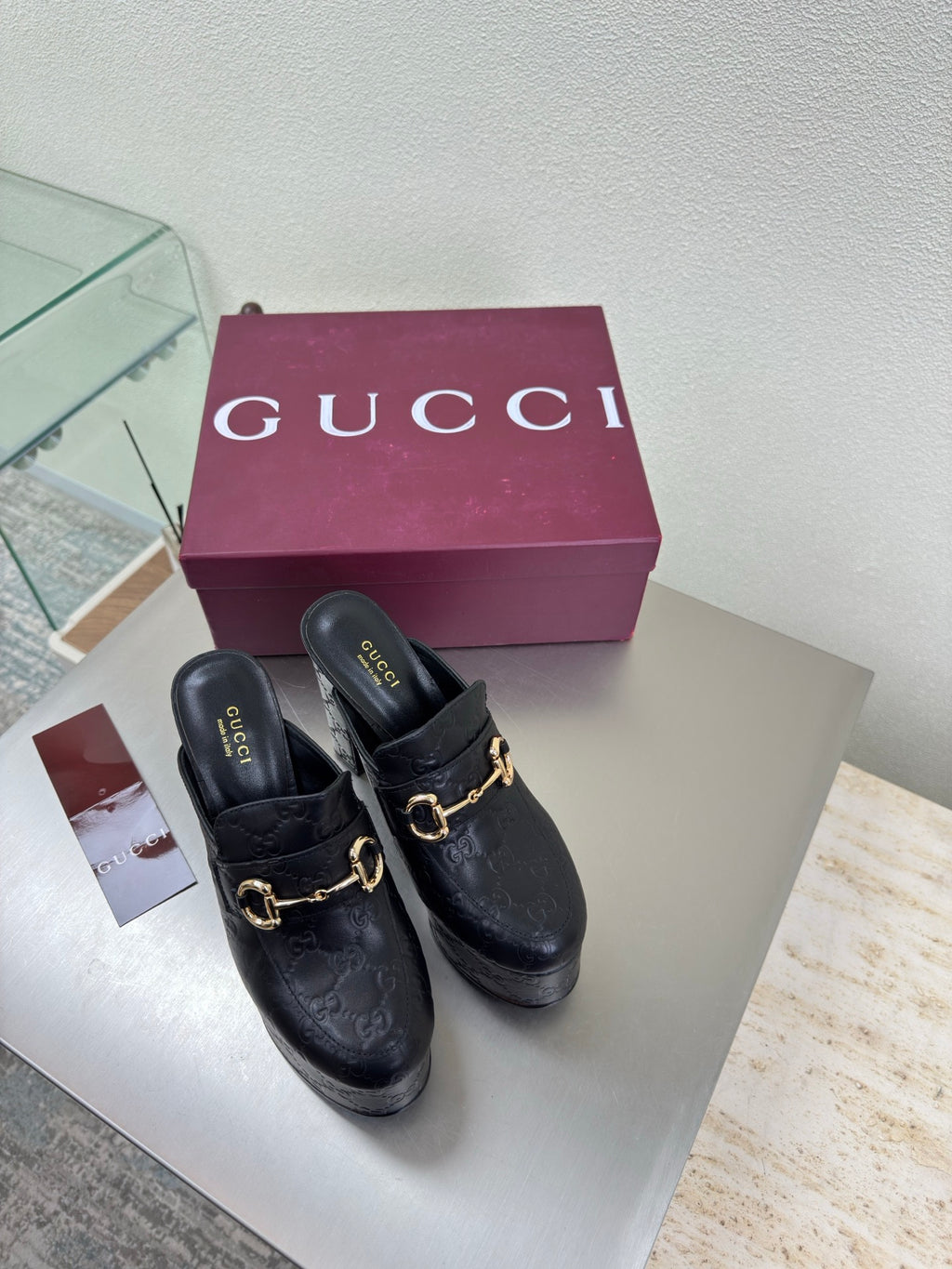 Black Gucci mule with gold horsebit detail and chunky block heel