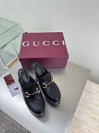 Black Gucci mule with gold horsebit detail and chunky block heel