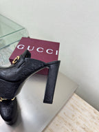 Black Gucci slide mule with gold horsebit and high block heel