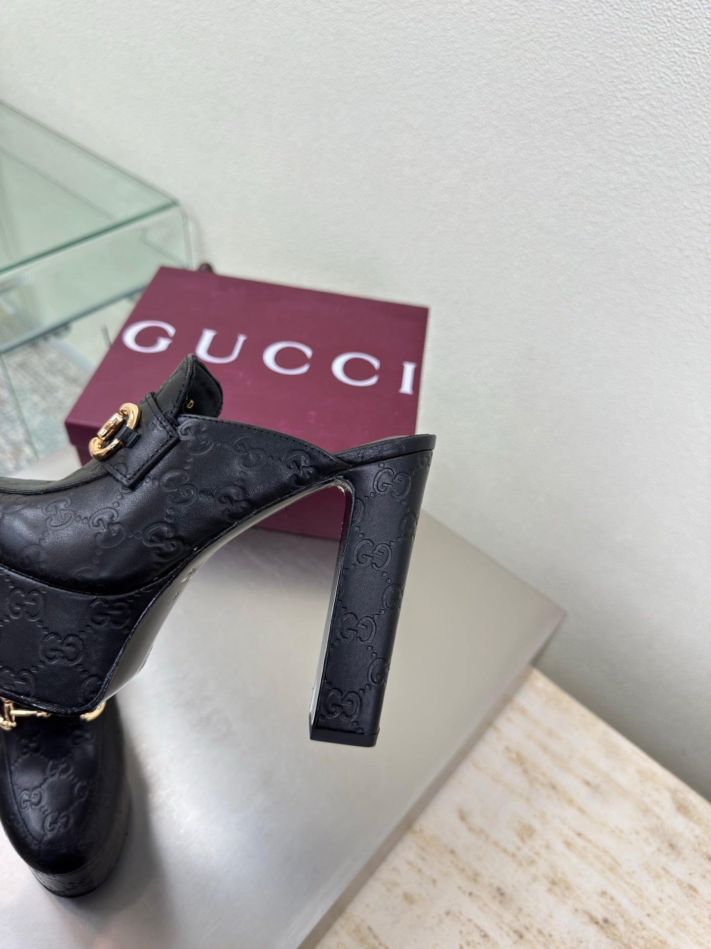 Black Gucci slide mule with gold horsebit and high block heel