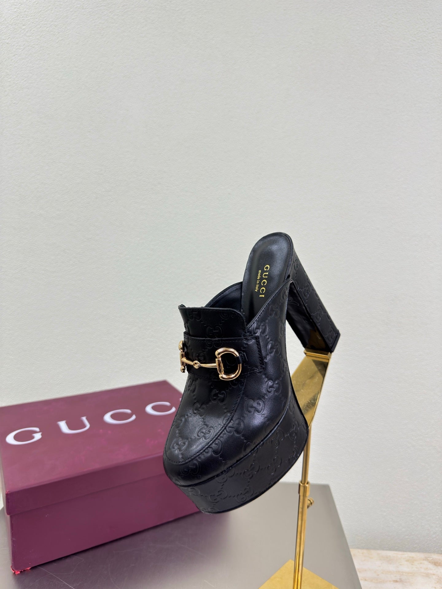 Black Gucci mule with gold horsebit hardware and block heel, side view