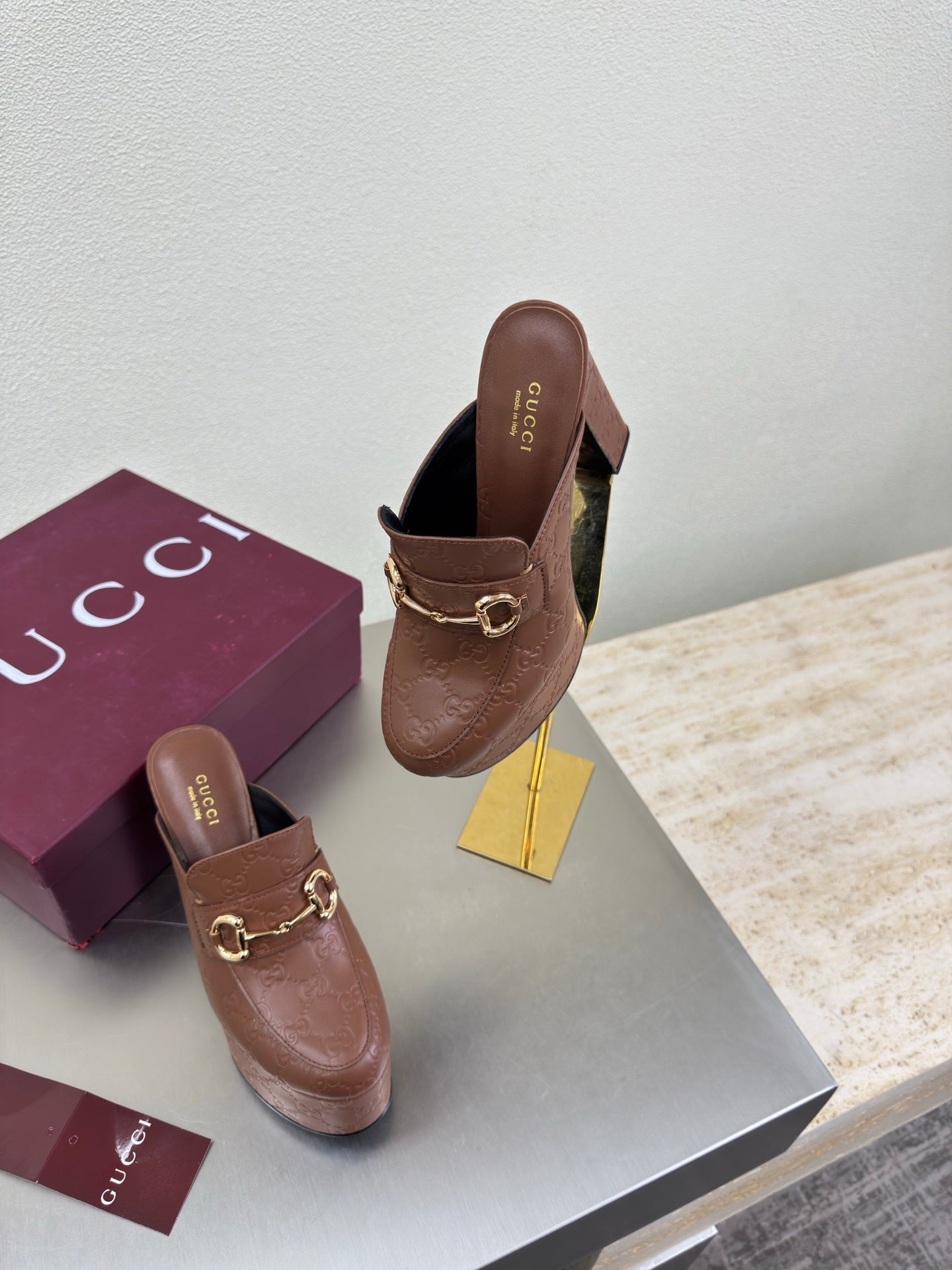 Brown Gucci platform mules with gold buckle hardware and logo pattern, box and pair
