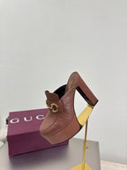 Brown Gucci platform mule with gold buckle strap and block heel, three-quarter view