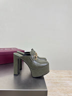 Gucci ladies platform mule with dark green upper, gold horsebit buckle and tall heel
