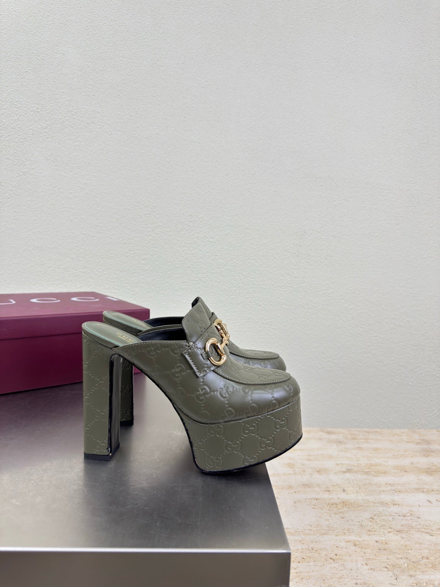 Gucci ladies platform mule with dark green upper, gold horsebit buckle and tall heel