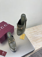Gucci ladies platform mules, dark green with gold horsebit buckle, angled side view