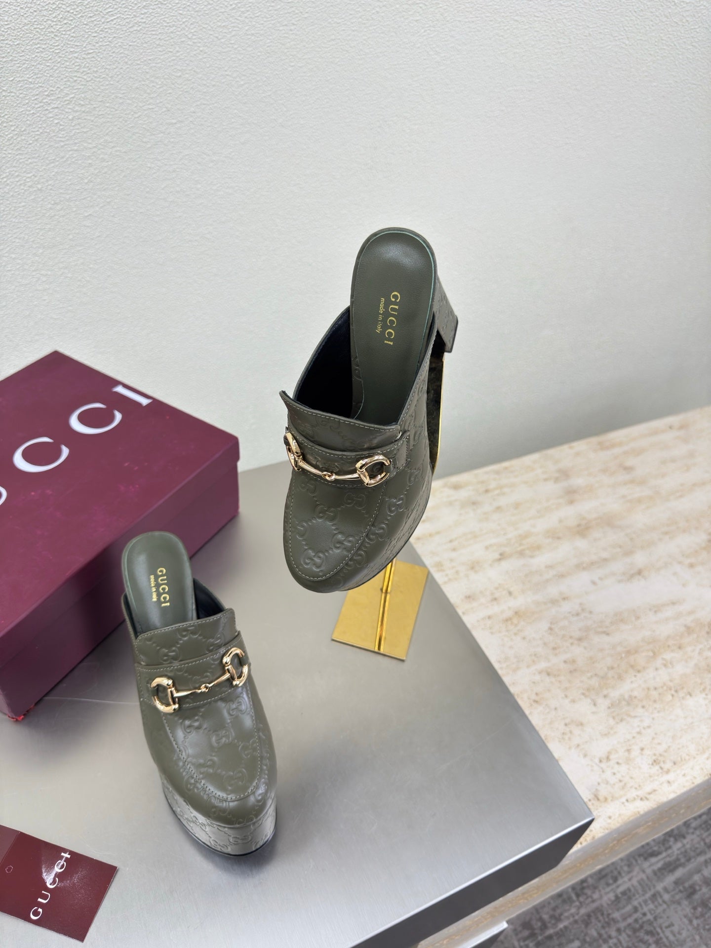 Gucci ladies platform mules, dark green with gold horsebit buckle, angled side view