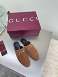 Women's brown monogram loafers with gold chain bit; black interior and sole