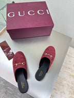 Gucci women's burgundy GG-pattern mule shoes with gold horsebit, shown on white box
