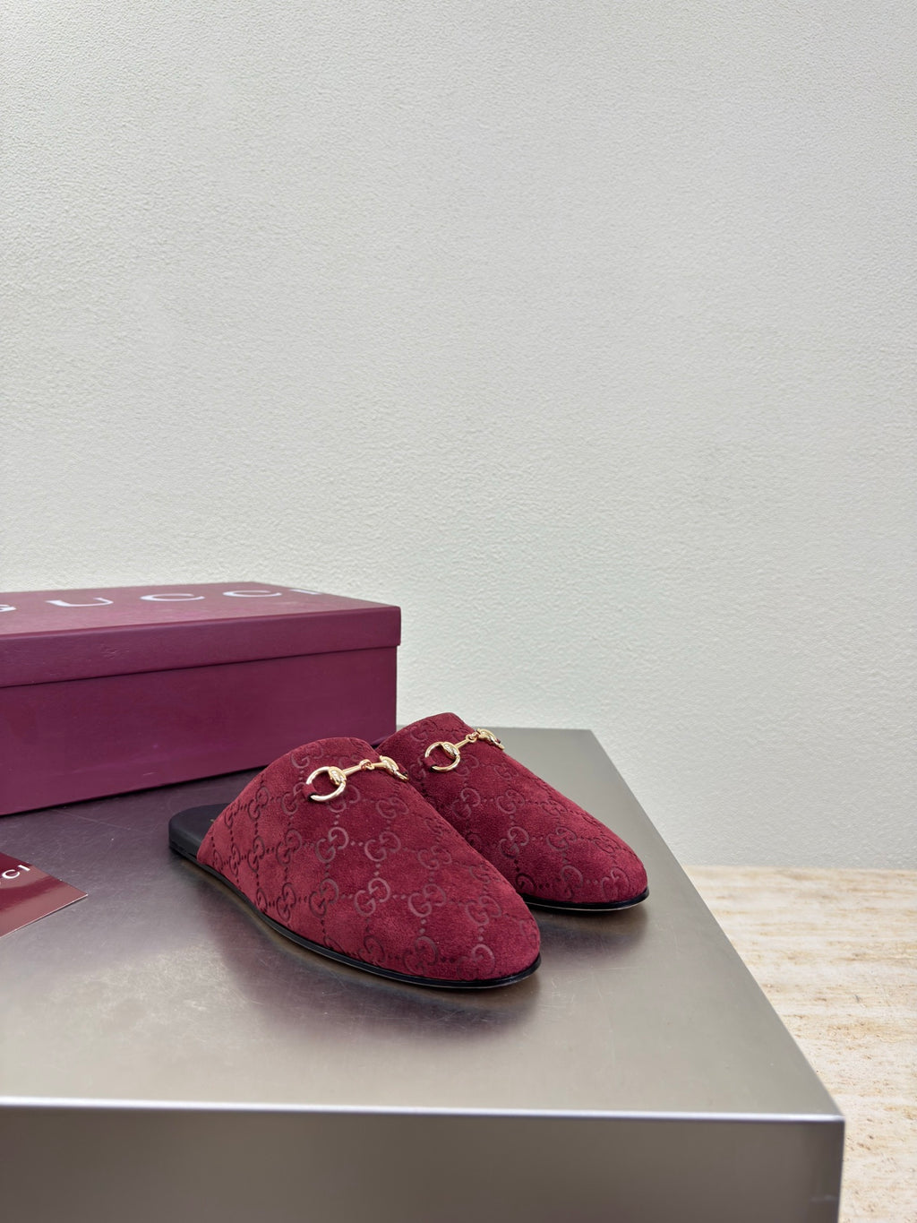 Gucci women's burgundy GG-pattern mule shoes with gold horsebit, on display box