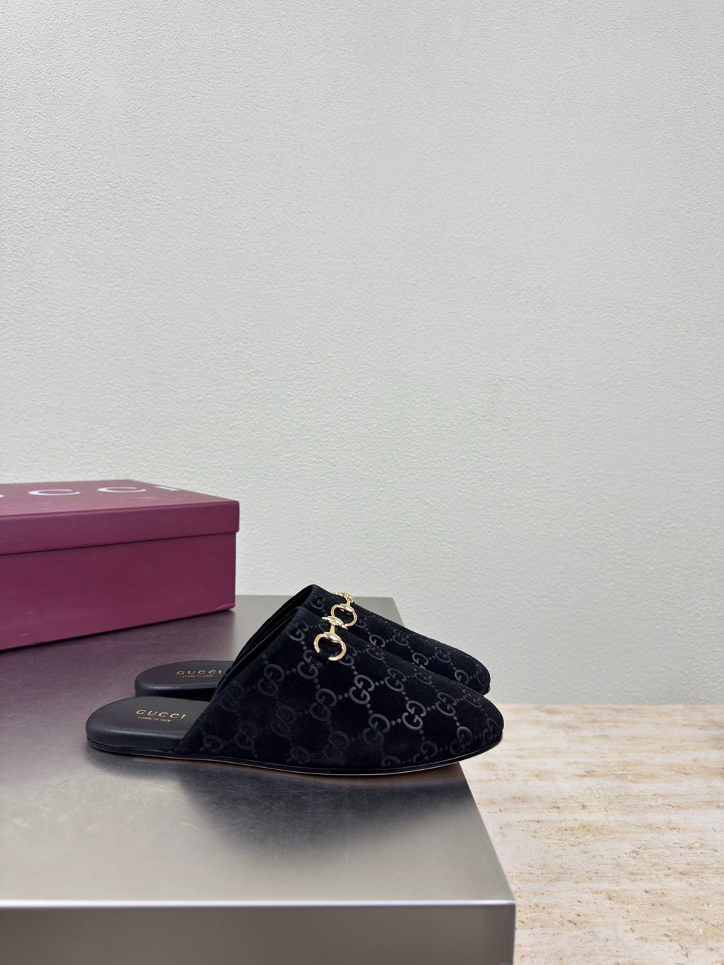 Black Gucci mule shoe with GG logo print and gold horsebit detail, single pair