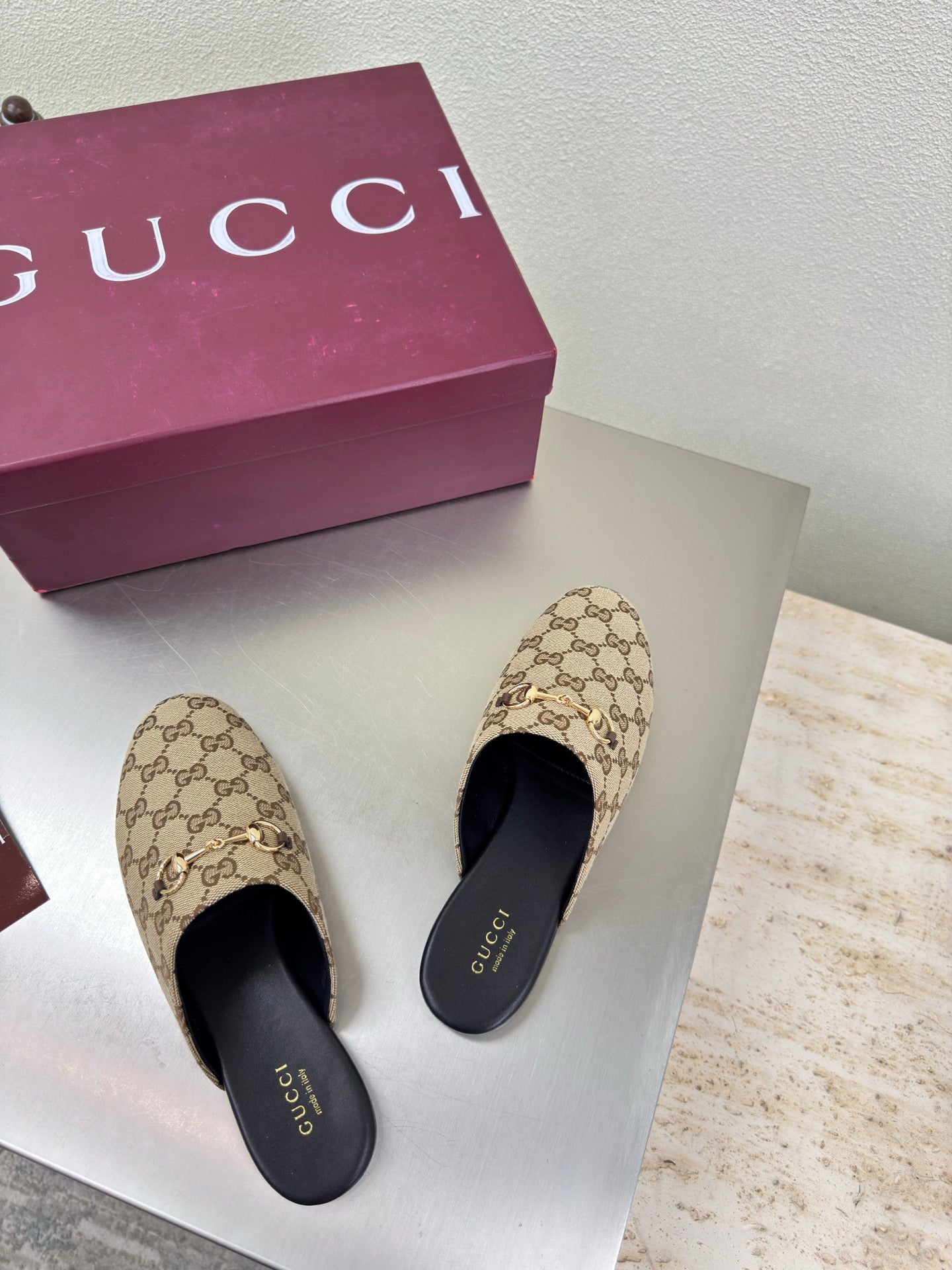 Gucci women’s GG-pattern slip-on loafers, front view pair
