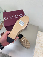 Gucci women’s GG-pattern slip-on loafers with cream sole and black trim