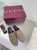 Gucci women’s GG-pattern slip-on loafers with black rubber sole detail
