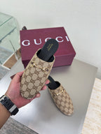 Gucci women’s GG-pattern slip-on loafers with black heel cup