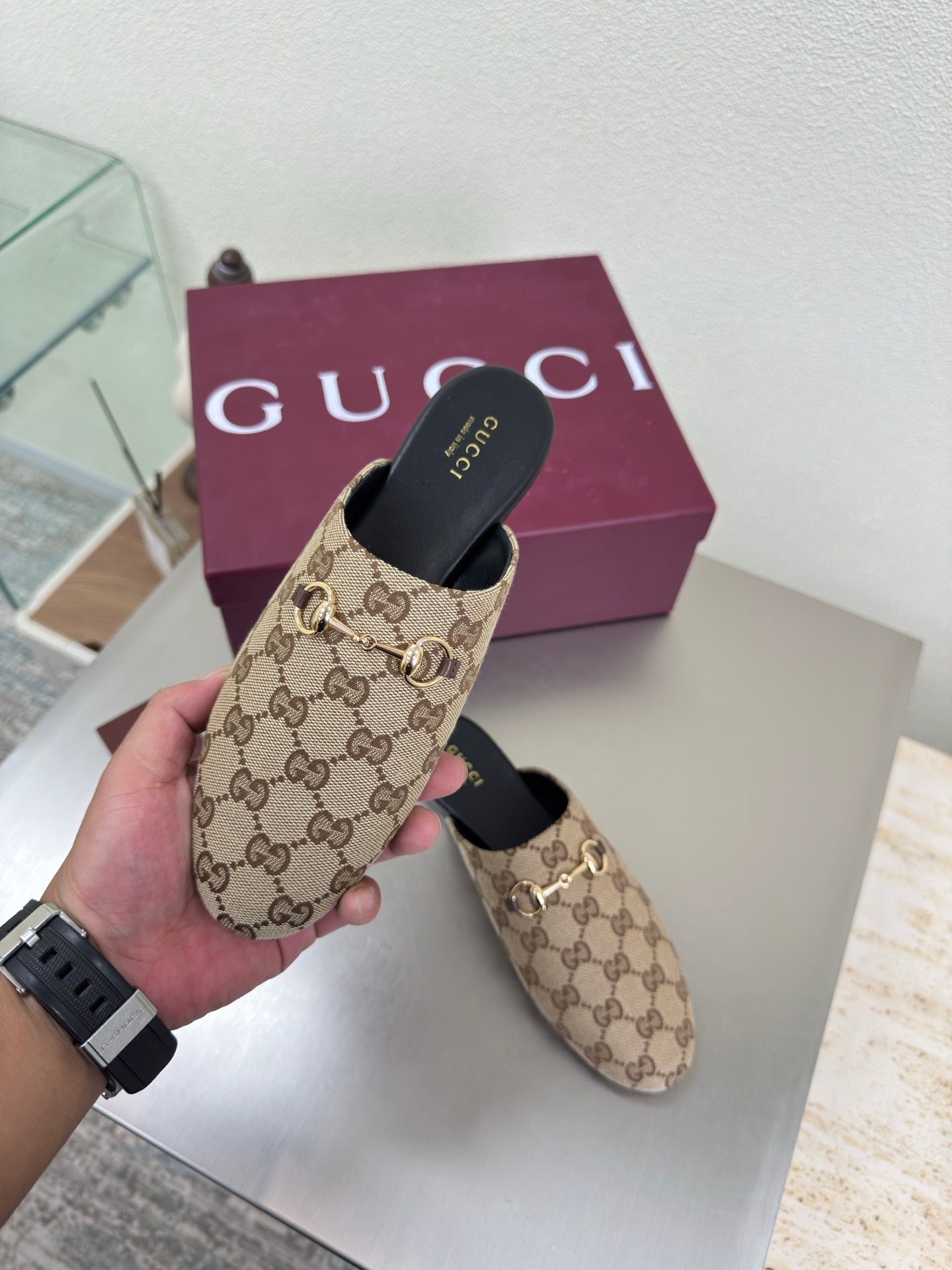 Gucci women’s GG-pattern slip-on loafers with black heel cup
