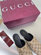 Gucci women’s GG-pattern slip-on loafers, black insoles and soles
