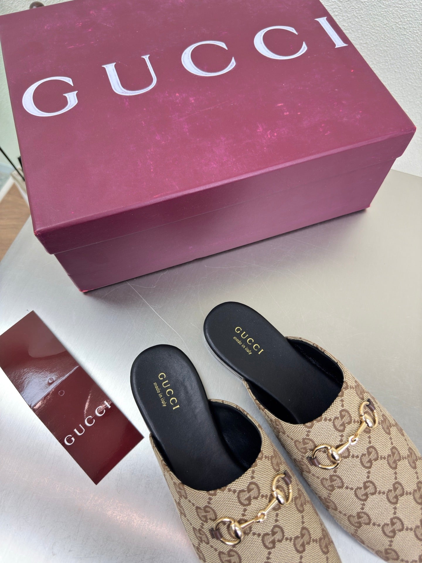 Gucci women’s GG-pattern slip-on loafers, black insoles and soles
