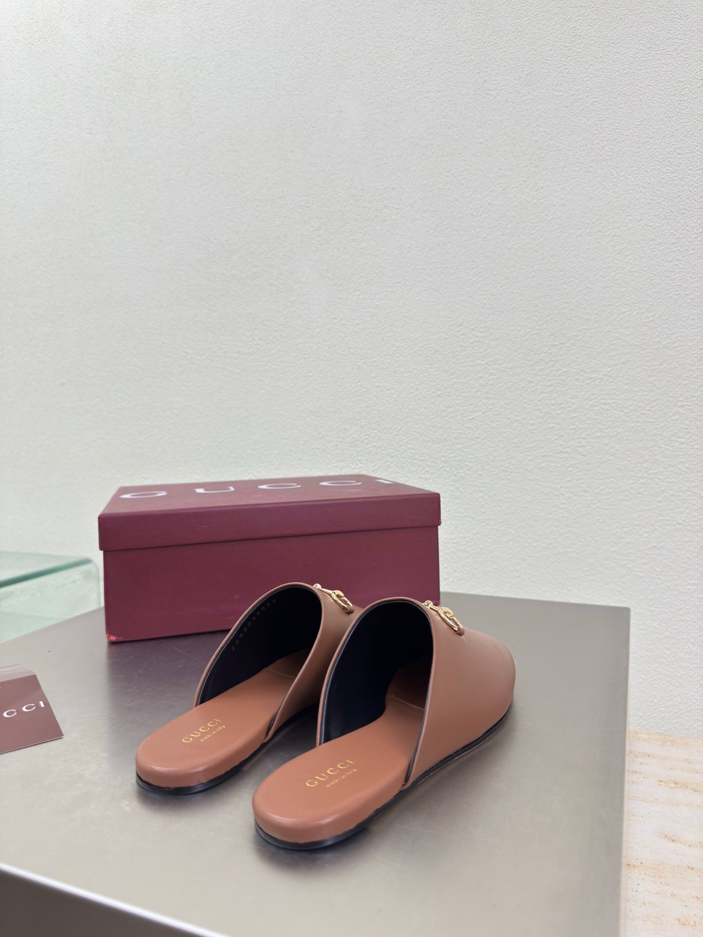 Gucci women's brown leather loafers with gold horsebit detail, top view