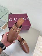 Gucci women's brown leather loafers with gold horsebit, side view