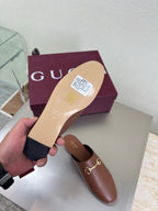 Gucci women's brown leather loafers with gold horsebit, sole visible