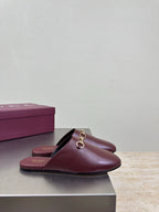 Burgundy leather slide mule with gold horsebit hardware and open heel opening