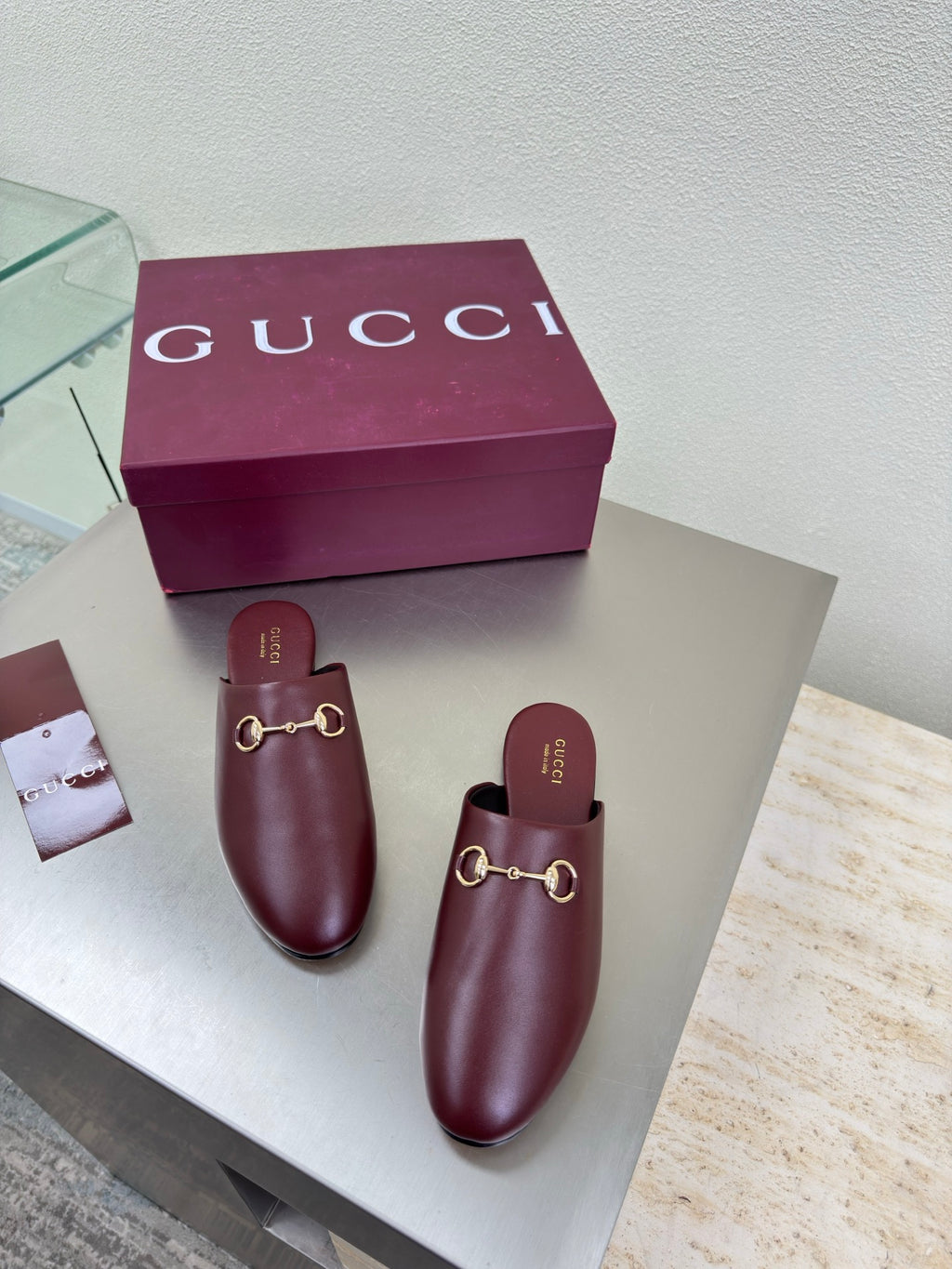 Pair of burgundy Gucci leather mules with gold horsebit detail and open heel