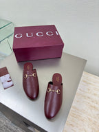 Pair of burgundy Gucci leather mules with gold horsebit detail and open heel
