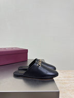 Gucci black leather mule on a box, gold horsebit detail and low profile heel