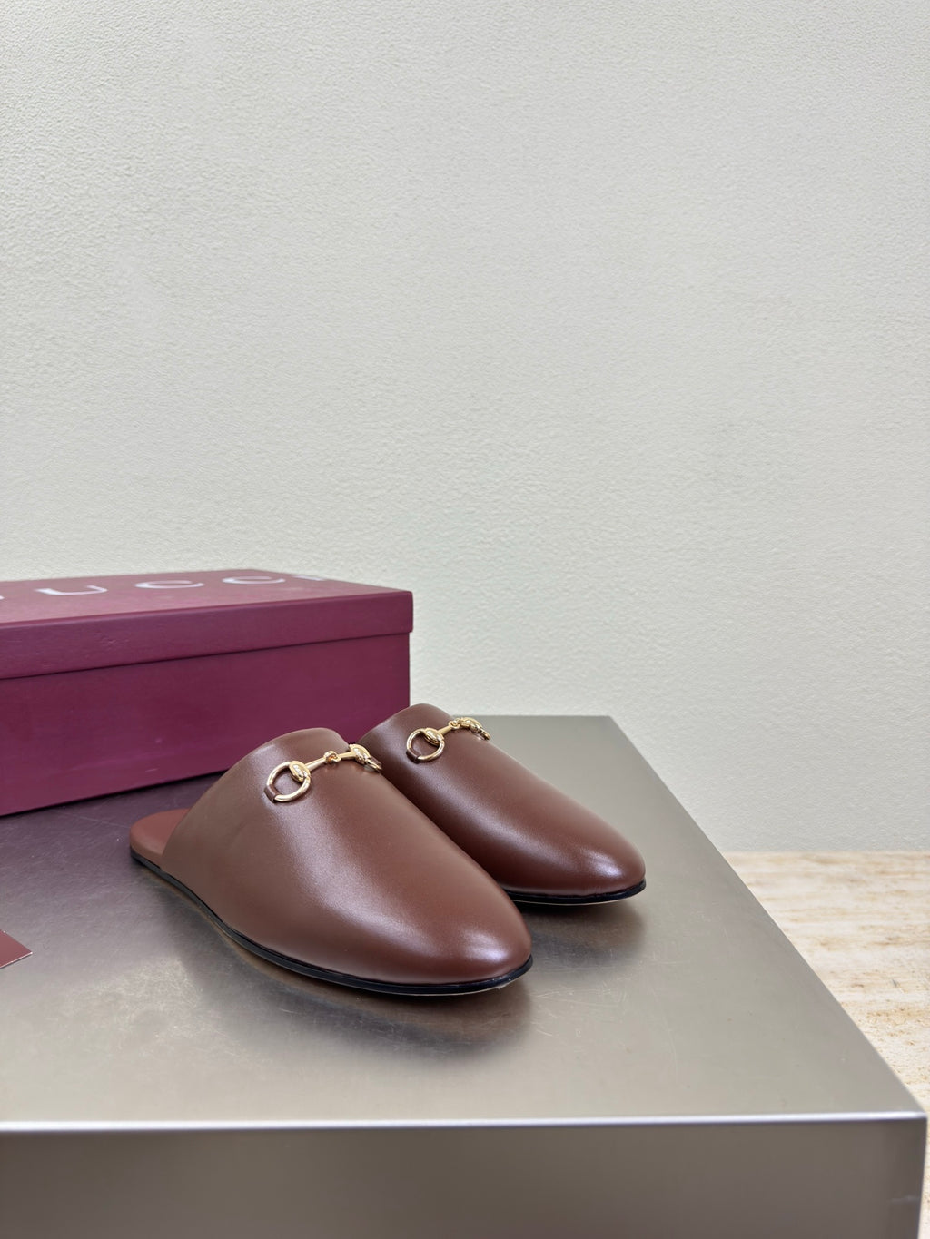 Brown Gucci leather slip-on mules with gold horsebit hardware