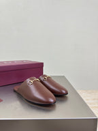 Brown Gucci leather slip-on mules with gold horsebit hardware