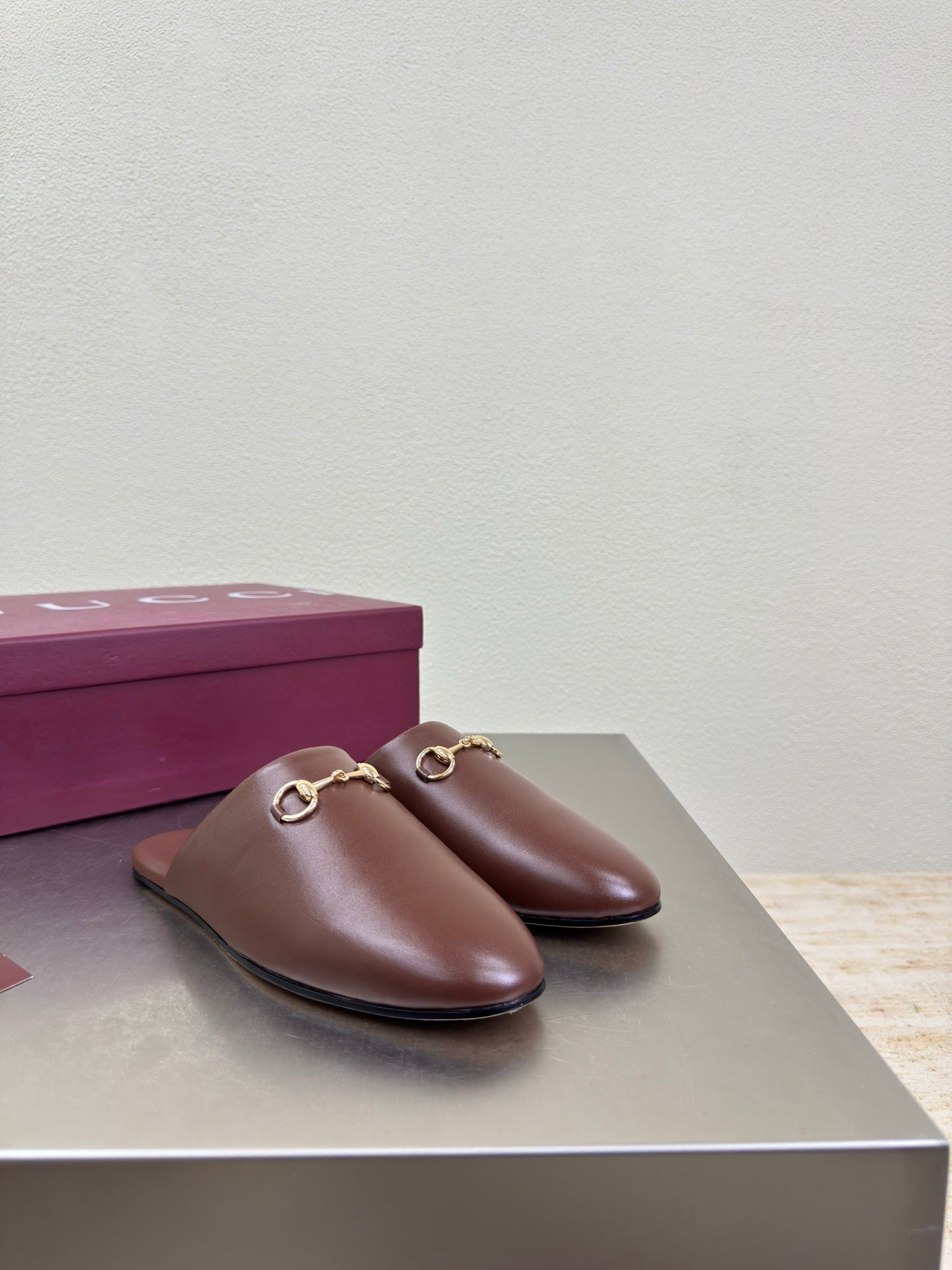 Brown Gucci leather slip-on mules with gold horsebit hardware
