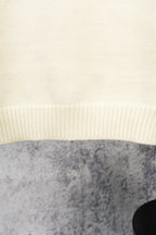 Ivory knit sweater hem with ribbed band detail