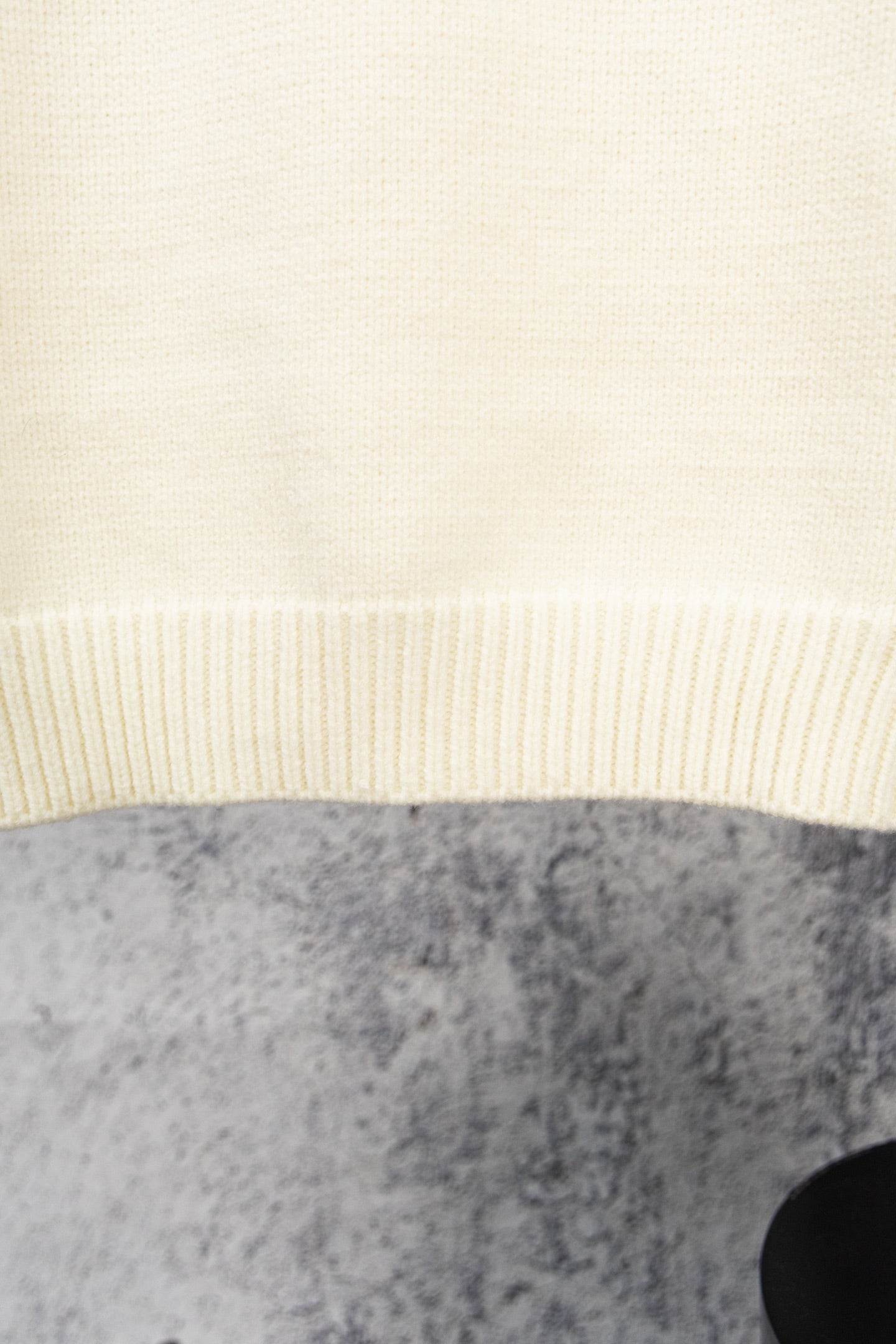 Ivory knit sweater hem with ribbed band detail