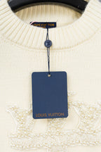 Ivory knit sweater front with beaded trim and hanging Louis Vuitton tag