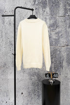 Ivory long-sleeve knit sweater on hanger with ribbed crew neck