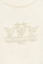 Ivory knit sweater with beaded crest lettering detail