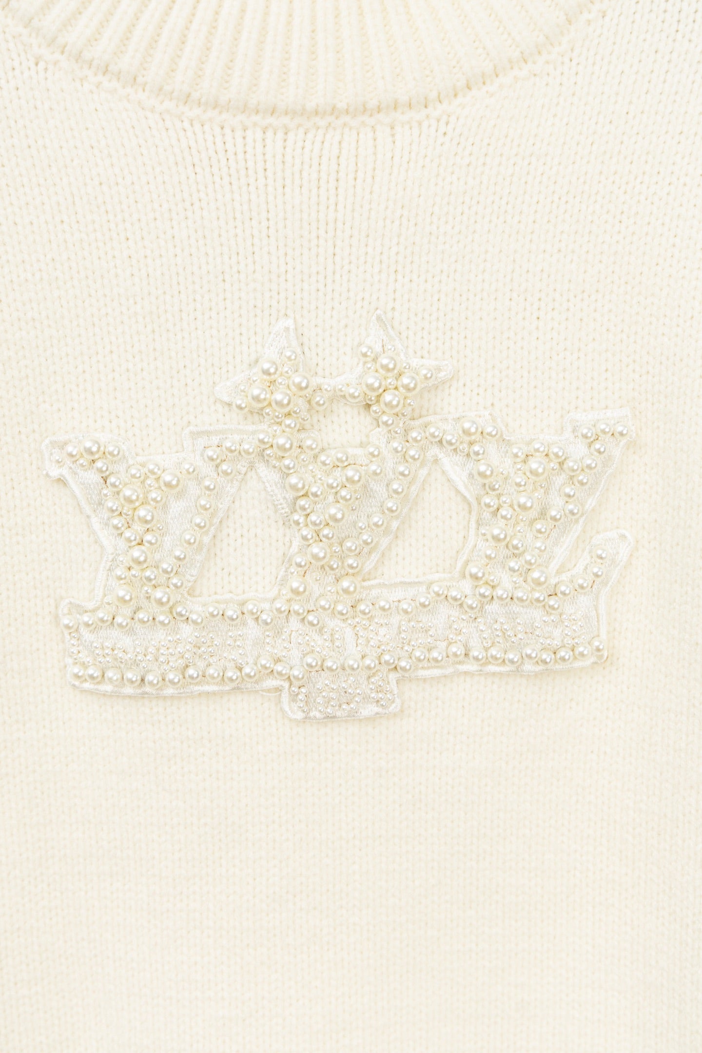 Ivory knit sweater with beaded crest lettering detail